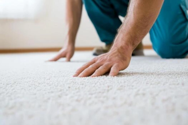 Worker laying velvet carpet